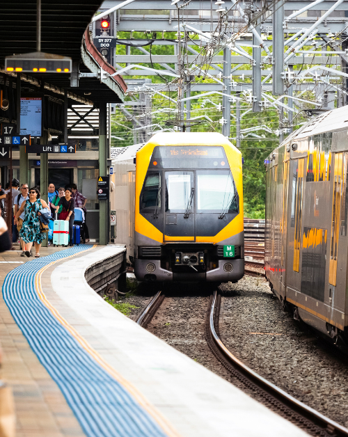 Melbourne train platform with waiting passengers and approaching train